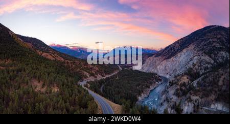 An aerial view of a winding road in a mountain valley at sunrise near Lytton, BC, Canada. Stock Photo