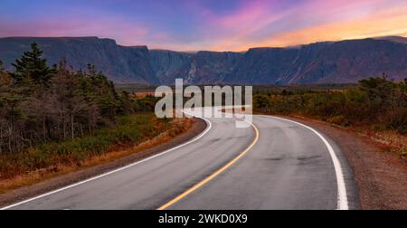 A curvy road at sunrise in Gros Morne National Park, Canada. Stock Photo