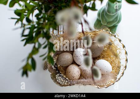Easter eggs and easter bunny under willow and boxwood branches Stock Photo