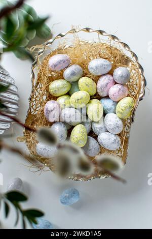 Easter eggs and easter bunny under willow and boxwood branches Stock Photo