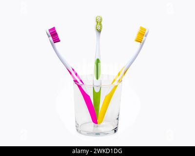 Toothbrushes in glass isolated on white Stock Photo