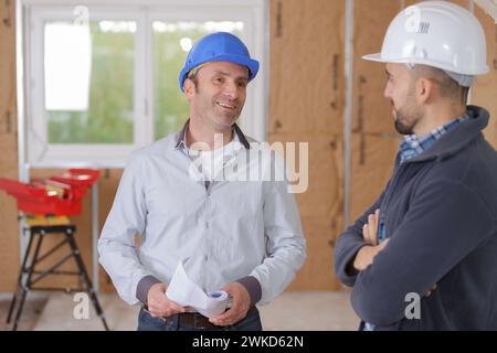 senior architect and young builder discussing the unfinished project Stock Photo