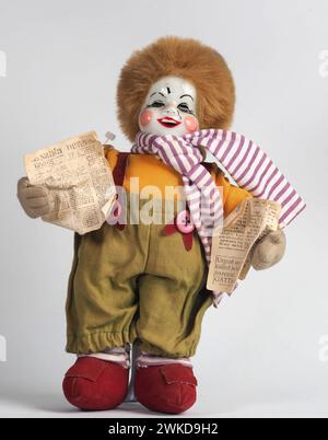 Garham, Germany. 19th Feb, 2024. Vintage German doll red-haired white clown with newspapers in hands. Porcelain dolls appeared in the 18th century in France. Credit: SOPA Images Limited/Alamy Live News Stock Photo