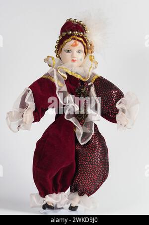 Garham, Germany. 19th Feb, 2024. Porcelain Italian doll depicting the hero of the Commedia Dell'arte in a red suit. Porcelain dolls appeared in the 18th century in France. Credit: SOPA Images Limited/Alamy Live News Stock Photo