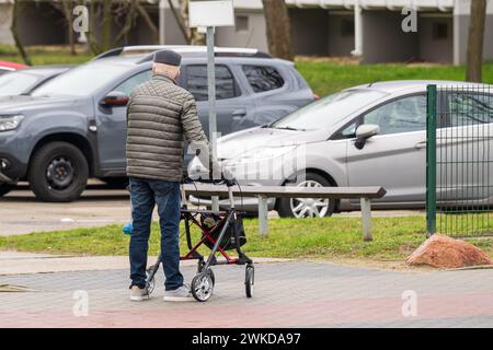 An elderly man on the move with a rollator Stock Photo