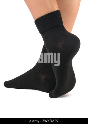 Side view of beautiful woman foot dressed in new nice and soft natural cotton fabric blank black socks isolated on white background. Wearing and sport Stock Photo