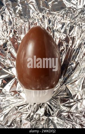 Easter chocolate egg in the foil of the opened package Stock Photo