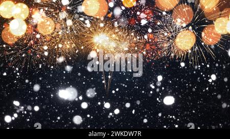 Amazing golden fireworks with snow on the starry sky with a yellow bokeh light.  New Year 2024 and Christmas card Stock Photo