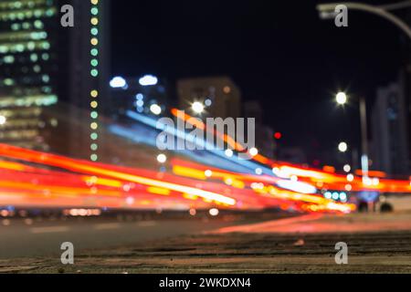 Traffic road with lights at night, bokeh urban background. City and red lights. Street Stock Photo