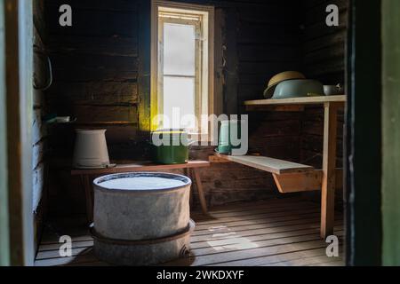 Sauna steam room. Wooden benches and accessories for sauna. Interior of old sauna. Stock Photo