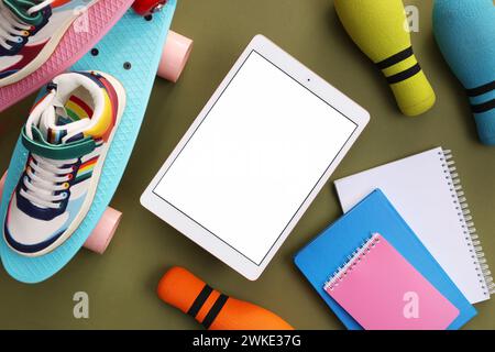 Flat lay composition with modern tablet on olive background. Space for text Stock Photo