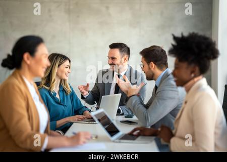 Team leader discussing and brainstorming new approaches and ideas with colleagues. Stock Photo