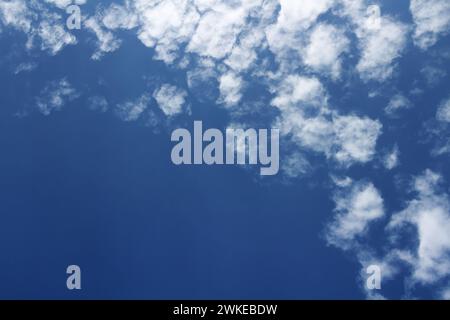 Little white clouds in the blue sky. Weather formation. Stock Photo