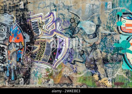 Colorful artistic graffiti on the wall of the dike or levee at maritime port of Varna, Bulgaria, Europe, EU Stock Photo