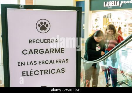 Merida Mexico,Zona Industrial,Galerias Merida shopping mall,inside interior,sign notice warning,carry pets dogs up down escalator,woman women lady fem Stock Photo