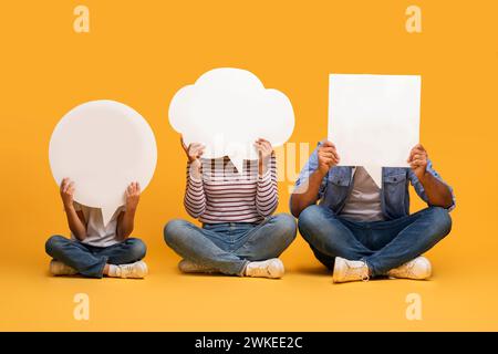 Thoughts Diversity. Black Father, Mother And Son Hiding Behind Empty Speech Bubbles Stock Photo