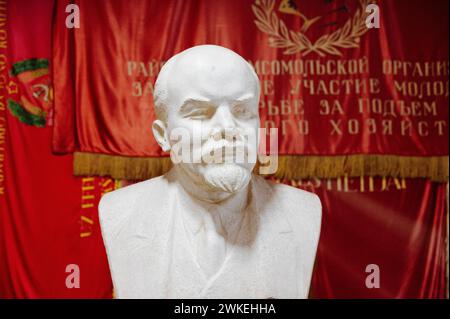 Jan Schmidt-Whitley/Le Pictorium - Illustrative pictures of, Lithuania. 19th Feb, 2024. lithuania/Baltic countries/Druskininkai - A bust of Lenin in front of red and gold Soviet flags. Grutas Park is an open-air museum featuring a collection of statues and other emblematic objects from the Soviet era. It was founded in 2001 around 130km south-west of Vilnius. Credit: LE PICTORIUM/Alamy Live News Stock Photo