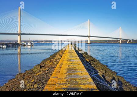 UK, Scotland, South Queensferry, Port Edgar Marina Jetty and Queensferry Crossing over the Firth of Forth. Stock Photo