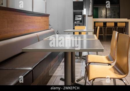 Spacious dining area with a communal table and comfortable seating in a restaurant. Table Top wooden counter Bar Restaurant. Cafe interior with wooden Stock Photo