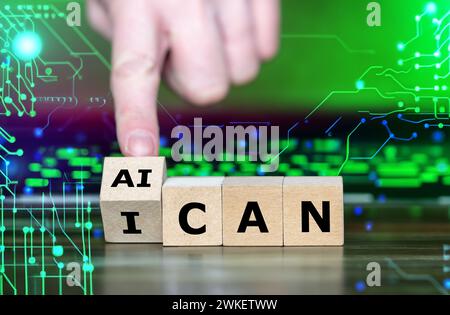 Hand turns wooden cube and changes the expression 'I can' to 'AI can'. Symbol for jobs done by artificial intelligence. Stock Photo