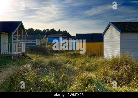 Hunstanton, Norfolk, UK - Colourful beach huts in the sand dunes of Old Hunstanton pictured on a sunny day Stock Photo