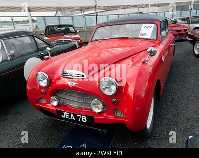 Three-quarters Front View of a  Red, 1953 Jensen Interceptor, on sale in  the Iconic Auction, at the 2023 Silverstone Festival Stock Photo