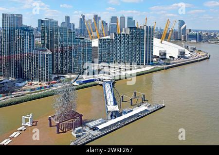 Greenwich Pier Peninsular high tide River Thames modern high rise developments beside O2 arena roof Canary Wharf landmarks distant  London England UK Stock Photo