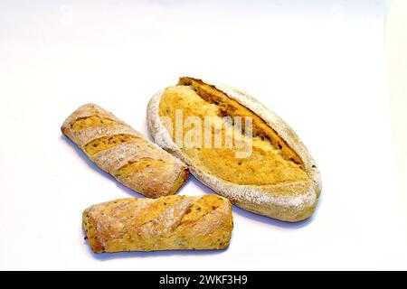 Wheat bread and two short baguettes are on a white table Stock Photo