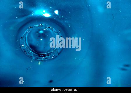 The falling drop of water created a crown of waves. Stock Photo
