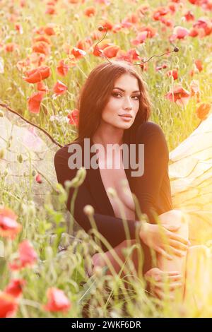 girl in a field of poppies in a black bodysuit . glamor photo Stock Photo