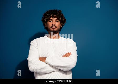Photo of young professional project manager indian freelancer man folded hands posing serious face isolated on dark blue color background Stock Photo