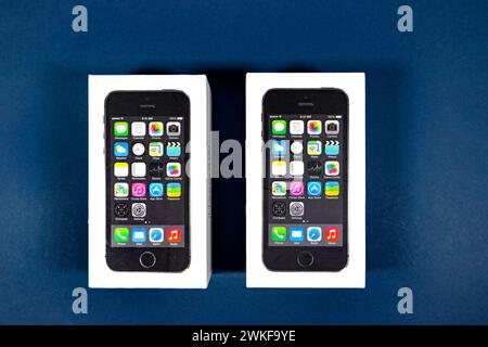 Apple iPhone 5 (s) boxes packaging on blue studio background Stock Photo