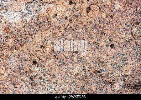 Rough natural red  granite stone pattern, close up background photo texture Stock Photo