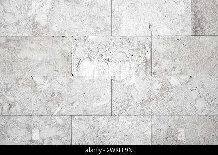 White decorative stone tiling on the front wall, background photo texture Stock Photo