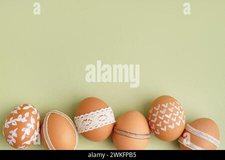 Composition with decorated Easter eggs on green background Stock Photo