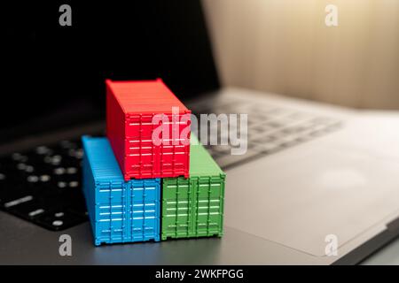 Ship container on laptop keyboard. Trade, economics and transport industry. Production of containers. Import or export. Registration of deliveries and Stock Photo