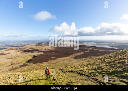 A walker standing just below the summit of West Lomond looking towards East Lomond Hill Stock Photo