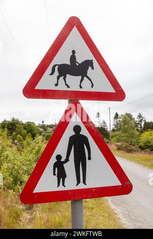 red triangle road sign warning of pedestrians walking Stock Photo