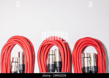 Red microphone cables bundled on white background Stock Photo
