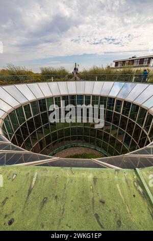 Warsaw, Poland - October 14 2023: Big circular and glassy hole with flowers inside with view to rooftop lookout platform at garden on top of the unive Stock Photo