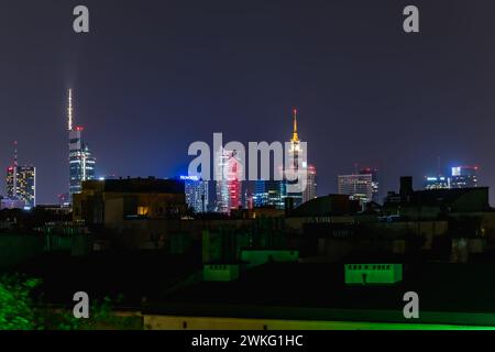 Warsaw, Poland - October 11 2023: Beautiful night cityscape of high skyscrapers of Warsaw city highlighted by colorful lights under clear sky Stock Photo