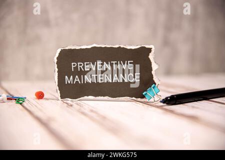 Preventive Maintenance text written on a notebook with pencils. Stock Photo