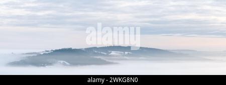The iconic radio mast atop Norwood Edge stands over a sea of mist during a winter temperature inversion on a chilly morning in Nidderdale. Stock Photo