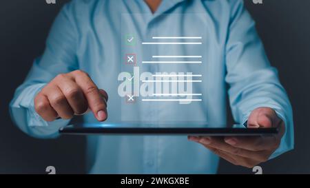 Checklist and filling survey form online. Document management system, DMS. Quality control and accuracy Check, Businessman using tablet online survey Stock Photo