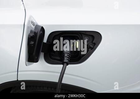 Electric car being charged Stock Photo