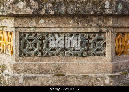 Photograph of traditional Vietnamese ventilation block pattern on an ancient stone wall Stock Photo