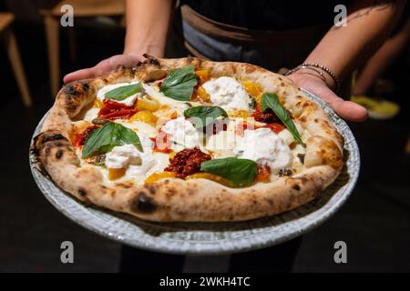 Pizza with burrata cheese, sun dried tomatoes and basil, Italy Stock Photo