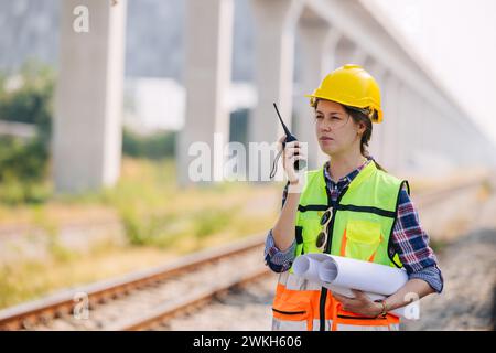 Engineer caucasian women railway tracks service team working on site survey check maintenance inspection train track for construction and safety Stock Photo