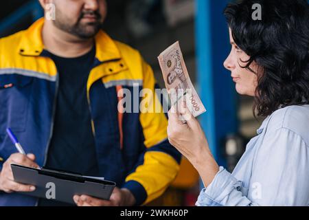 customer women unhappy dissatisfied expensive high cost pay bill for car service pricey expense lost money for fix replace auto part service Stock Photo