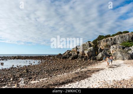 Couple walking on the beach at Stokes Bay, Kangaroo Island, South Australia Stock Photo